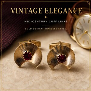May include: A pair of gold-toned metal cuff links featuring a crescent-shaped design with a central deep red faceted stone. The text VINTAGE ELEGANCE, MID-CENTURY CUFF LINKS, and BOLD DESIGN. TIMELESS STYLE. is visible in the upper portion of the image.