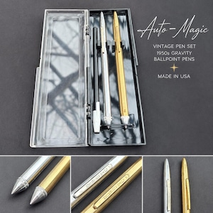 May include: A vintage pen set from the 1950s, comprising three ballpoint pens in a clear plastic case. The pens are silver, black, and gold-coloured. The case is open, displaying the pens. Text on the image reads "Auto-Magic" and "Made in USA".