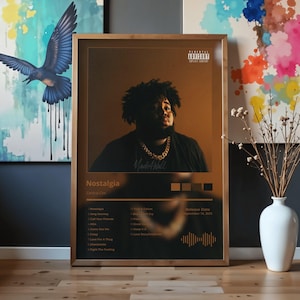 May include: Framed poster featuring a portrait of a person with a gold chain, with the album title "Nostalgia" and tracklist. The poster has a gold and brown color scheme, with a parental advisory warning.
