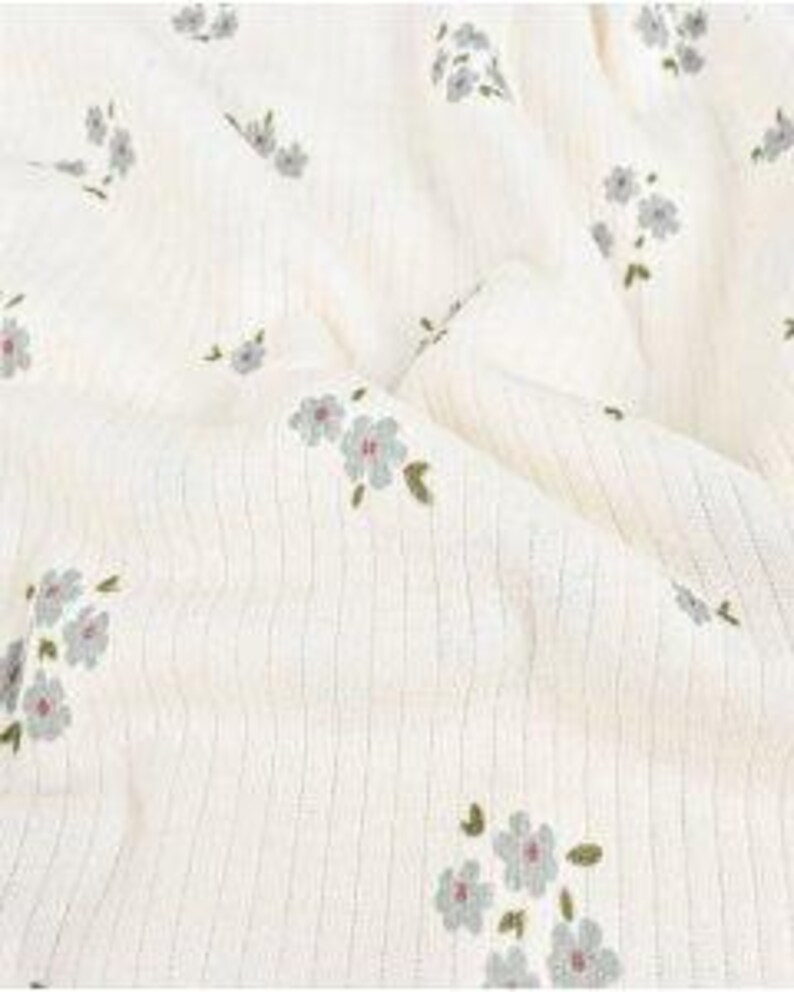 Rib knit fabric detail of Flowers (Article 6075) Dark Old Green with scattered floral pattern on green base