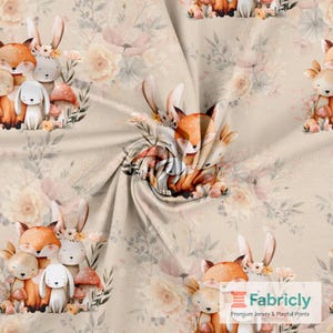 May include: Fabric with a repeating pattern of woodland animals and floral elements. The design features foxes, rabbits, and mushrooms in a soft color palette of beige, orange, and cream. The fabric is suitable for various sewing projects.
