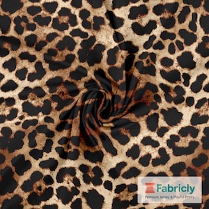 May include: A close-up of a leopard print fabric. The fabric has a tan base with black and brown spots. The material is slightly swirled, adding depth and texture. The Fabricly logo is visible in the bottom right corner of the image.