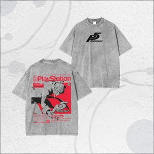 May include: Two grey t-shirts with short sleeves. One shirt has the text "P5 PERSONAS" in black. The other shirt features a red and black graphic with Japanese text and the PlayStation logo. The graphic includes the text "PERSONAS".