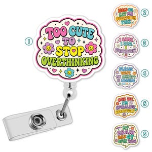 May include: A badge reel featuring a scalloped, cloud-shaped acrylic topper with the text 'TOO CUTE TO STOP OVERTHINKING' in colorful, retro-style lettering, surrounded by small flowers, hearts, and stars. Five additional topper designs are shown.