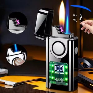 May include: A silver-coloured electric lighter with a black flip-top lid. The lighter has a digital display showing "100" with green lights. The flame is a combination of yellow and blue. The design includes a circular button and a small inset image.