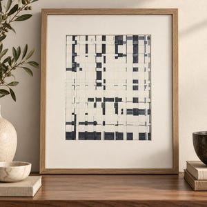May include: A framed wall art piece featuring an abstract grid pattern of intersecting dark navy blue and off-white vertical and horizontal rectangular blocks. The artwork is enclosed in a light-toned wooden frame with a wide, cream-coloured mat border.