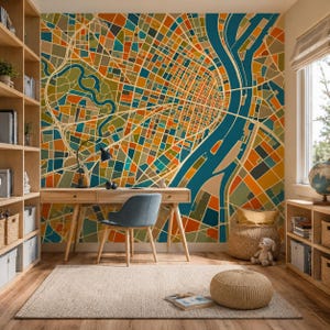 May include: A colorful geometric map mural in shades of orange, blue, green, and yellow adorns a wall. A wooden desk with a blue chair sits in front of the mural. The room is furnished with bookshelves, a rug, and a window.