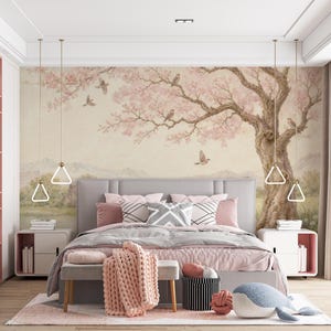 May include: A bedroom with a large bed, featuring a gray headboard and pink bedding. A mural of a tree with pink blossoms and birds adorns the wall. The room includes matching nightstands, a bench, and a pink rug, creating a serene atmosphere.