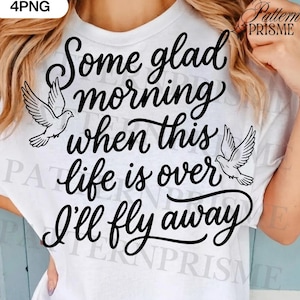 May include: White t-shirt with the text "Some glad morning when this life is over I'll fly away" in a black script font. Two dove illustrations are on either side of the text. The shirt is a crew neck.