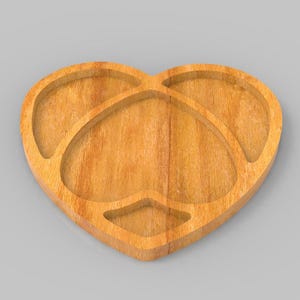 May include: A heart-shaped wooden serving tray with four compartments. The tray is made of light-colored wood and has a smooth finish. The design includes a central heart shape and three additional heart-shaped sections.