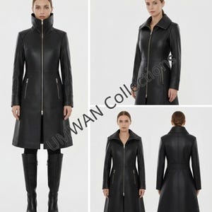 May include: A black leather coat with a high collar and a full-length zipper. The coat features a flared skirt and long sleeves. The model is wearing black boots. The coat has two front pockets with zippers. The coat is a classic and stylish outerwear piece.