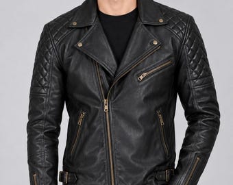 May include: A black leather motorcycle jacket featuring a quilted pattern on the shoulders and upper sleeves, a notched lapel collar, antique brass-toned metal zippers, and adjustable side buckles at the waist, worn over a plain black shirt.