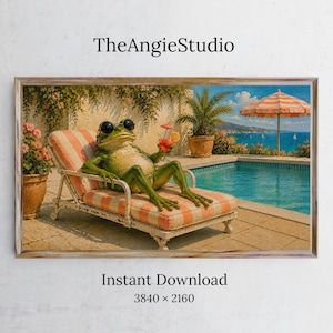 May include: A digital art print titled TheAngieStudio featuring a green frog wearing black sunglasses, lounging on a striped orange and white chaise longue by a swimming pool. The scene includes a potted plant, a cocktail, and a striped umbrella.