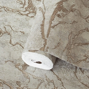 May include: A roll of wallpaper featuring a textured beige and light brown surface with an abstract, raised marble-like pattern. The design consists of irregular, flowing lines in a metallic bronze tone set against a matte, woven-look background.