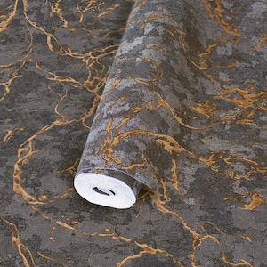 May include: A roll of wallpaper featuring a dark charcoal gray textured background with a prominent metallic gold vein pattern that mimics the appearance of natural marble stone. The surface has a matte finish with visible fabric-like texture.