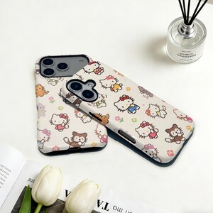 May include: Two phone cases with a repeating pattern of cartoon characters in various outfits and poses on a cream background. The cases have a black border and are designed for a smartphone.