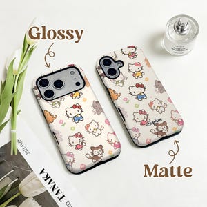 May include: Two phone cases with a repeating pattern of cartoon characters, flowers, and animals. One case is labeled "Glossy" and the other "Matte". The cases are white with a variety of colorful characters. One case has the name "Sophia" printed on it.