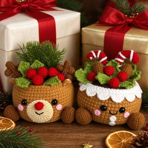 May include: Two round, tan crochet containers with embroidered faces. The left one features reindeer antlers, green leaves, and red berries. The right one has a white scalloped trim, red and white candy canes, green leaves, and red berries.