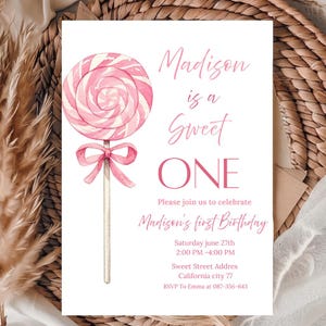 "Aesthetic Sweet One 1st birthday invitation for girls with pink watercolor swirl lollipop and bow."