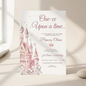 May include: A princess-themed invitation with a pink castle illustration. The text reads "One-ce Upon a time..." and invites guests to a royal celebration for Olivia's 1st birthday. Includes date, time, and RSVP information.