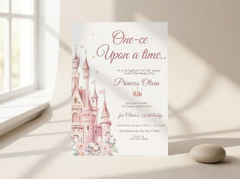 May include: A princess-themed invitation with a pink castle illustration. The text reads "One-ce Upon a time..." and invites guests to a royal celebration for Olivia's 1st birthday. Includes date, time, and RSVP information.