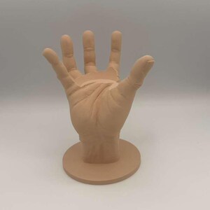 May include: A white ceramic mug with a black handle and the text "But First, Coffee" in a bold, black font. The mug is set against a blurred background, highlighting its clean design. The mug appears to be approximately 4 inches tall.