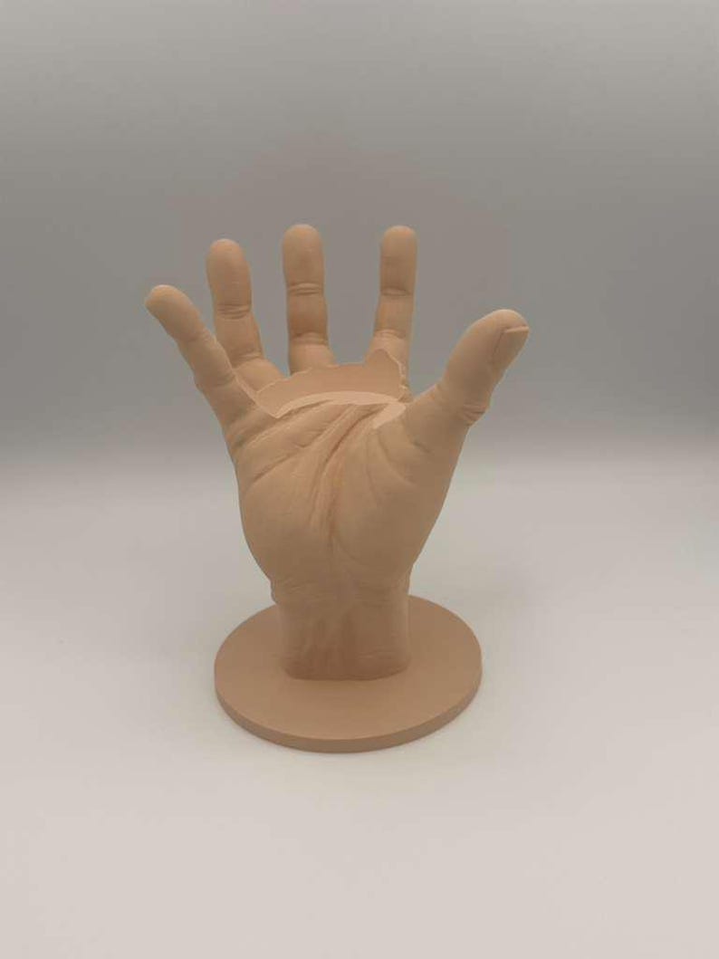 May include: A white ceramic mug with a black handle and the text "But First, Coffee" in a bold, black font. The mug is set against a blurred background, highlighting its clean design. The mug appears to be approximately 4 inches tall.