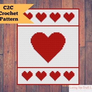 May include: C2C Crochet Pattern: A white crochet square with a red heart in the center and a row of red hearts at the top and bottom. The text "C2C Crochet Pattern" is in a yellow banner at the top of the image.