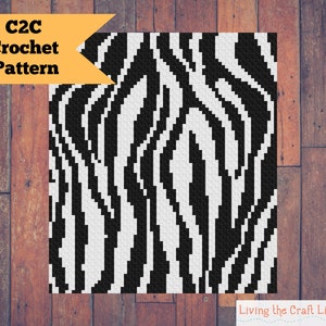 May include: C2C crochet pattern for a black and white zebra print design. The pattern is made up of squares, with black and white stripes.