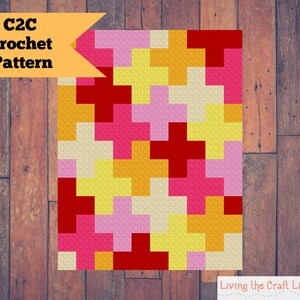 Puede incluir: Patrón de crochet C2C con un diseño colorido con cuadrados rojos, rosas, amarillos y crema.