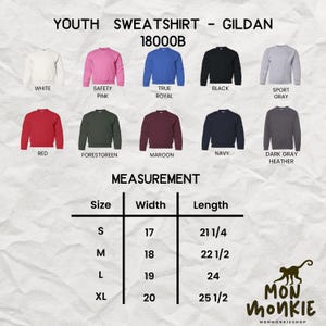 May include: A product image showcasing a variety of Gildan 18000B youth sweatshirts in various colors, including white, pink, blue, black, and gray. The image also includes a size chart with measurements in inches.