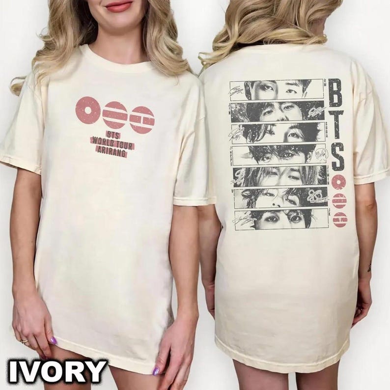 May include: Ivory-colored t-shirts with a graphic design. The front of the shirt features a pink circular design with the text "BTS WORLD TOUR ARIRANG". The back of the shirt has a vertical design with faces and the text "BTS".