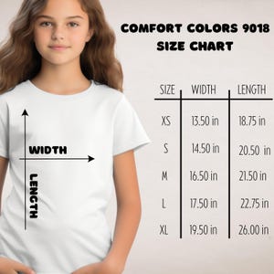May include: A young person wearing a white t-shirt. The image includes a size chart for Comfort Colors 9018 shirts, showing measurements in inches for width and length across sizes XS to XL. The chart also includes the text "WIDTH" and "LENGTH".
