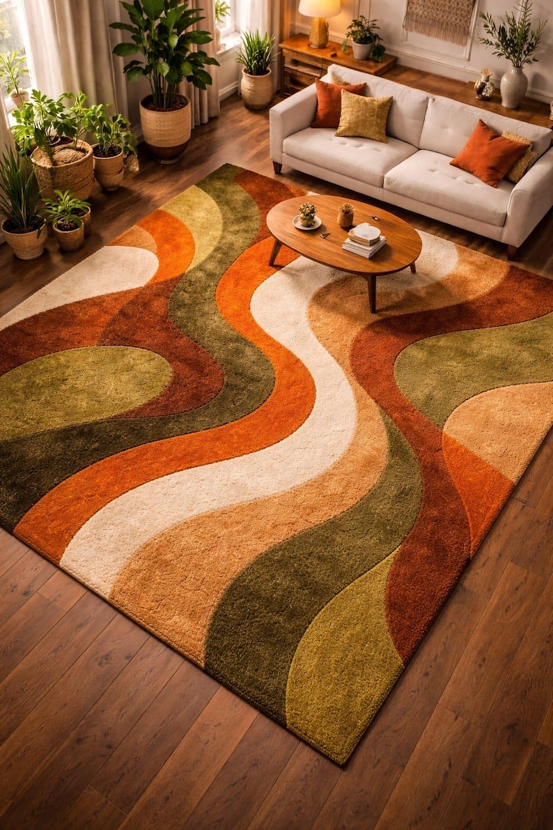 May include: A large, rectangular area rug with a retro design. The rug features a wavy pattern in shades of orange, brown, green, and cream. The rug is placed on a dark wood floor, and the room is decorated with plants and a sofa.