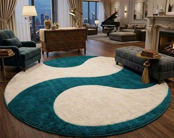 May include: A round area rug with a teal and cream yin-yang design. The rug is placed on a dark wood floor in a living room setting. The rug's design features a wavy pattern of teal and cream colors.