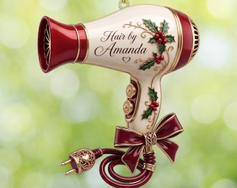 May include: A cream and red hair dryer ornament featuring the text Hair by Amanda, decorated with green holly leaves and red berries. The handle includes a dark red bow and a coiled cord with a gold plug featuring a small heart cutout detail.