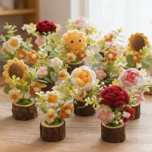 May include: A selection of handmade crochet flower arrangements. Each arrangement features a different flower type, including sunflowers, roses, and daisies, set in small wooden log planters. The flowers are in various colours, such as yellow, orange, pink, and red.