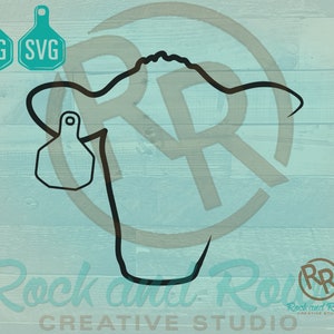May include: Black and white line art silhouette of a cow's head with a tag on the ear. The image is on a light blue woodgrain background. The text "Rock and Rowel Creative Studio" is at the bottom of the image.