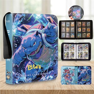 May include: A blue trading card binder featuring a graphic of the character Blastoise with water effects and the text Etta's Trading Card Binder. The binder includes internal pages for card storage and a black carrying strap on the side.