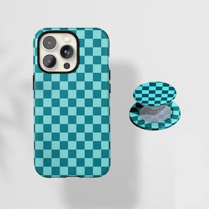 May include: A teal and dark teal checkered phone case and matching phone grip. The phone case is designed to fit a smartphone, and the grip is a round, collapsible stand for the back of the phone.