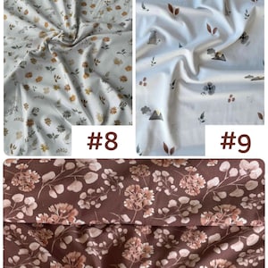 May include: Three fabric swatches labeled #8, #9, and #11. Swatch #8 features a white background with small brown and gray floral patterns. Swatch #9 displays a white background with mountain, flower, and leaf motifs. Swatch #11 shows a dark brown fabric with a dense pattern of light pink and white floral clusters.