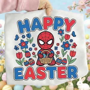 May include: White t-shirt featuring a cartoon Spider-Man holding a basket of Easter eggs. The words "HAPPY EASTER" are printed in red and blue. The design includes flowers, butterflies, and decorated Easter eggs.