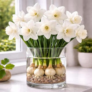 May include: A set of three ceramic mugs with a speckled, cream-colored glaze. Each mug features a different hand-painted design: a blue and green leaf, a yellow flower, and a red berry. The mugs have a simple, rounded shape.