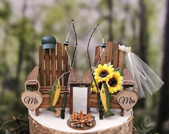 Fishing themed wedding cake topper with bonfire fire pit Mr and Mrs camping wedding topper Adirondack chairs Wild flowers fishing poles
