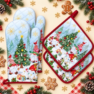 May include: A set of quilted oven mitts and square pot holders featuring a light blue background with a Christmas pattern of gnomes, decorated pine trees, wrapped gifts, and red cardinals, finished with a solid red fabric trim.