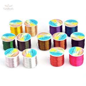 May include: A collection of twelve spools of fadeless copper wire for jewellery, each measuring 0.4mm in diameter. The spools feature a variety of vibrant colours including gold, silver, red, pink, green, purple, blue, brown, and copper tones.