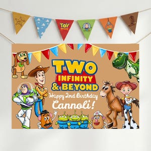 May include: A rectangular birthday banner featuring Toy Story characters including Woody, Buzz Lightyear, Jessie, Bullseye, Mr. and Mrs. Potato Head, Rex, Slinky Dog, and Aliens. The text reads TWO INFINITY & BEYOND Happy 2nd Birthday Cannoli!