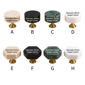 May include: A collection of eight stone cabinet knobs with brass-coloured bases. The top row features four round knobs in beige, black, green, and white, each 40mm in diameter and 32mm high. The bottom row shows four hexagonal knobs in the same colours, each 45mm in diameter and 32mm high.