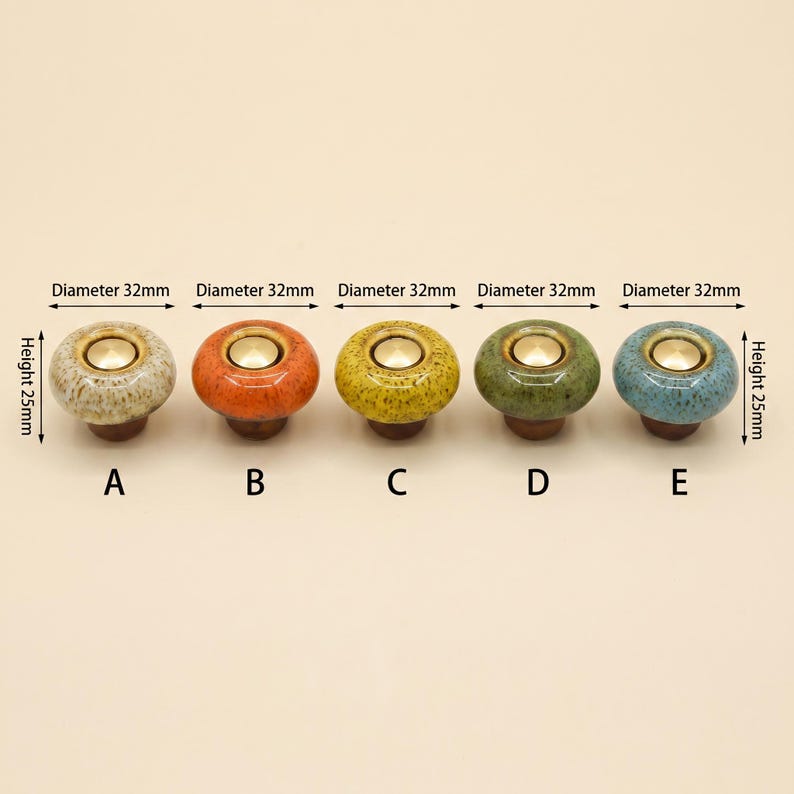 May include: Five round ceramic cabinet knobs labeled A through E, each featuring a central gold-tone metal inlay. The knobs are speckled in beige, orange, yellow, green, and blue. Each knob has a diameter of 32mm and a height of 25mm.