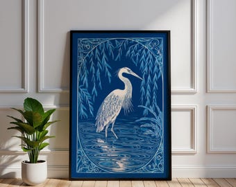 May include: A framed art print featuring a detailed illustration of a heron standing in water. The artwork is primarily blue and white, with the heron in the center, surrounded by stylized water and foliage. The print is in a black frame.